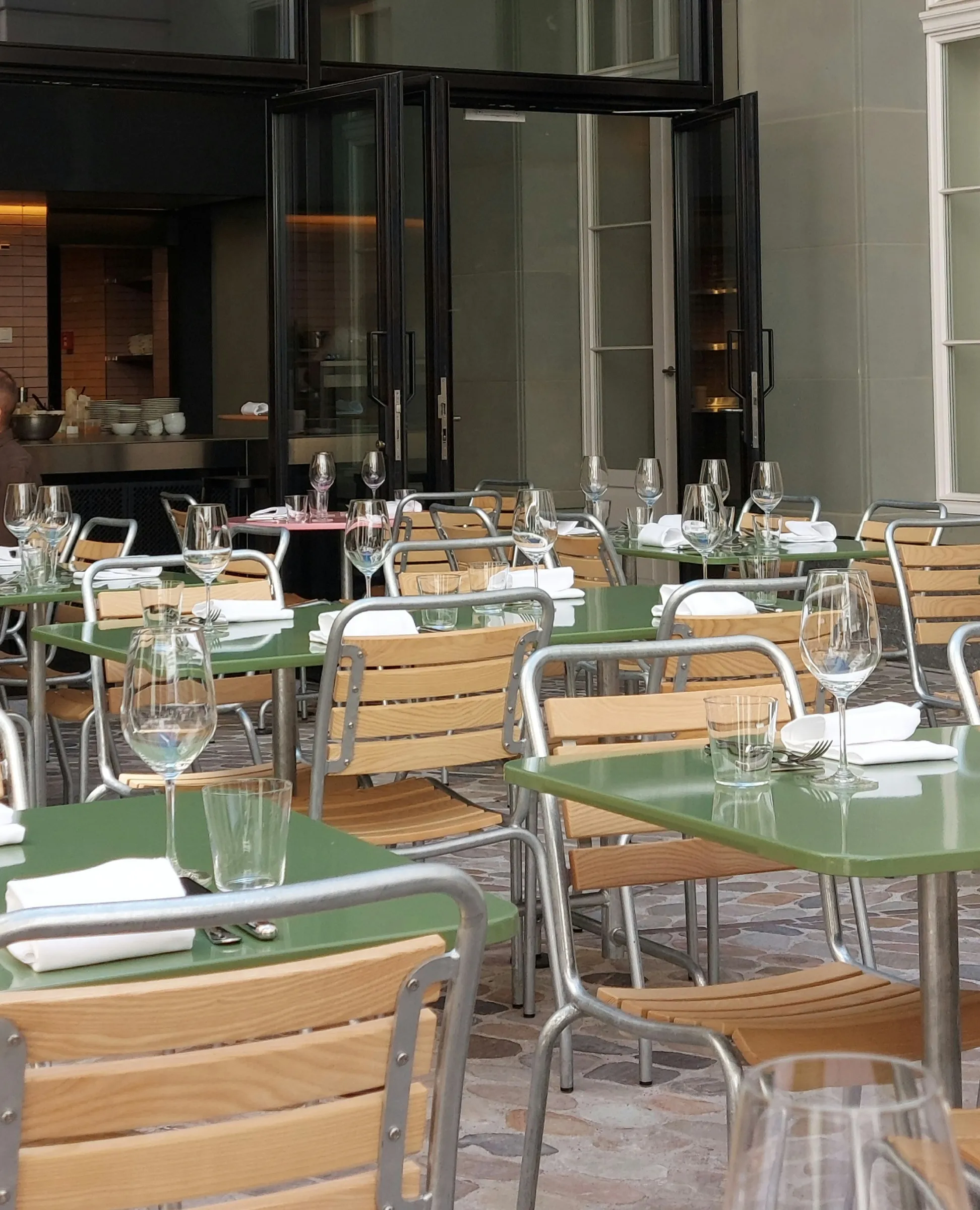 Terrace of Brasserie Kaiser in the Kaiserhaus courtyard with green metal tables