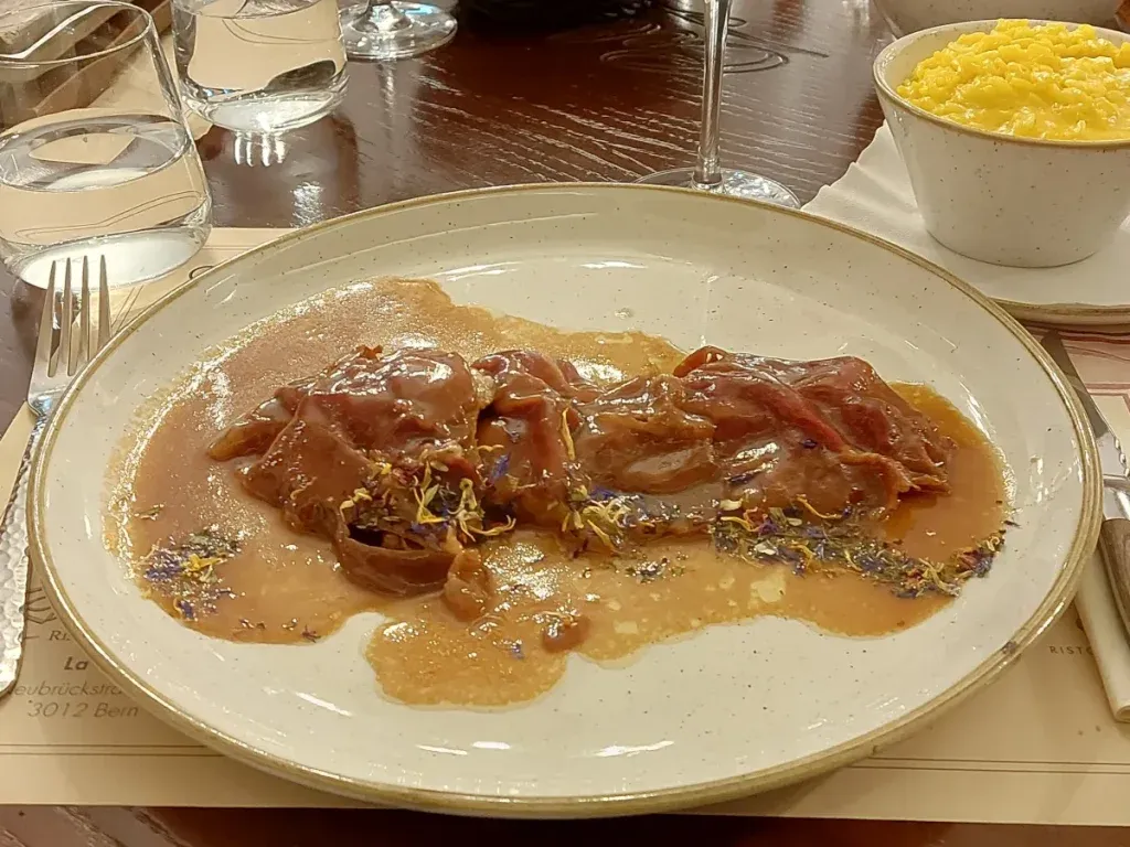 Saltimbocca in brown Marsala sauce with saffron risotto at Celina Bern