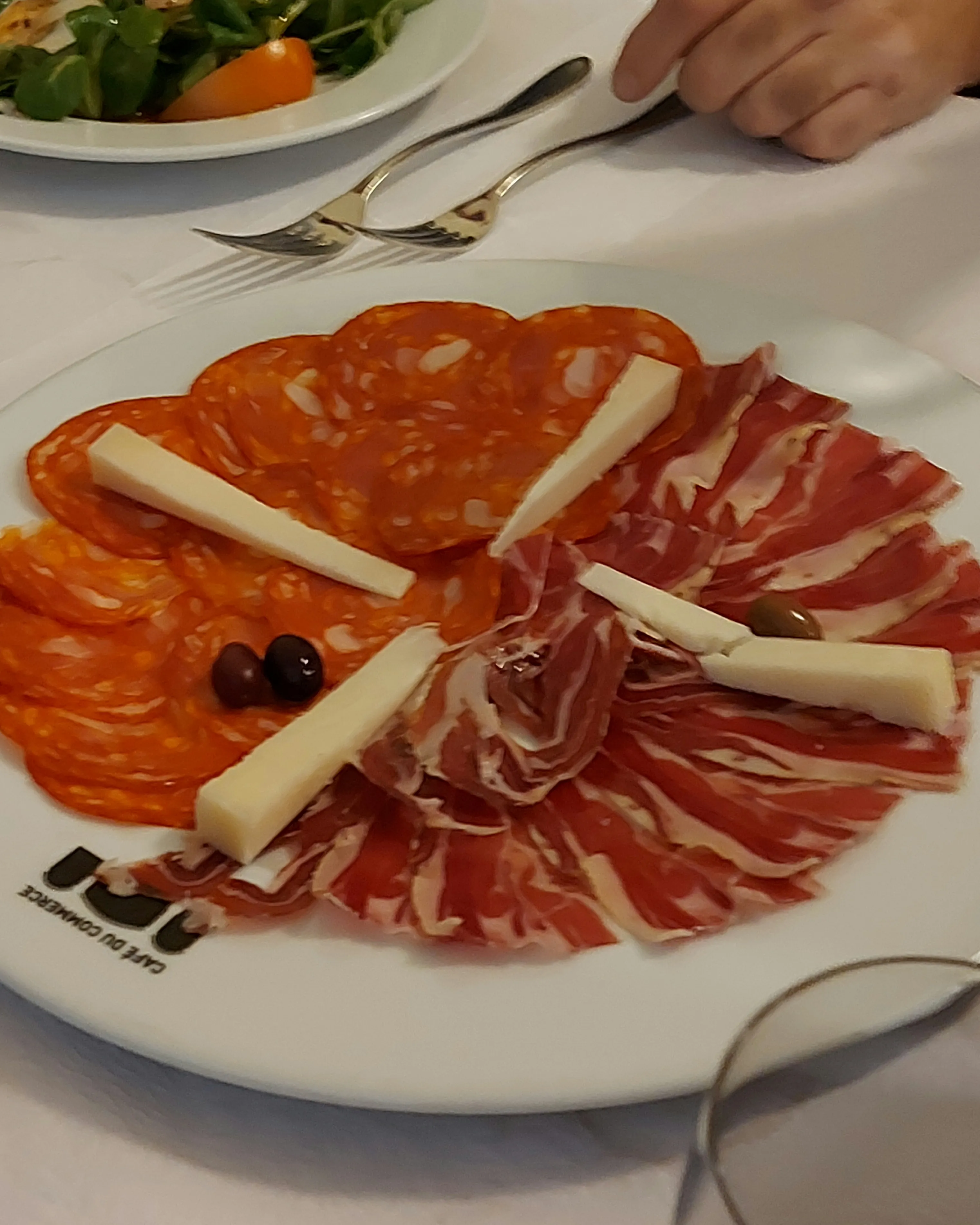 Tapas plate with chorizo, Jamón Serrano, cheese and olives at Commerce Bern