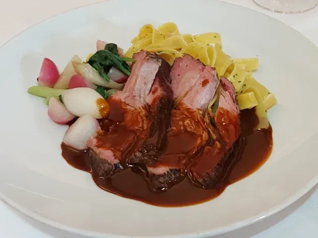Barbecue veal neck roast with seasonal vegetables and pasta at Haberbüni Bern