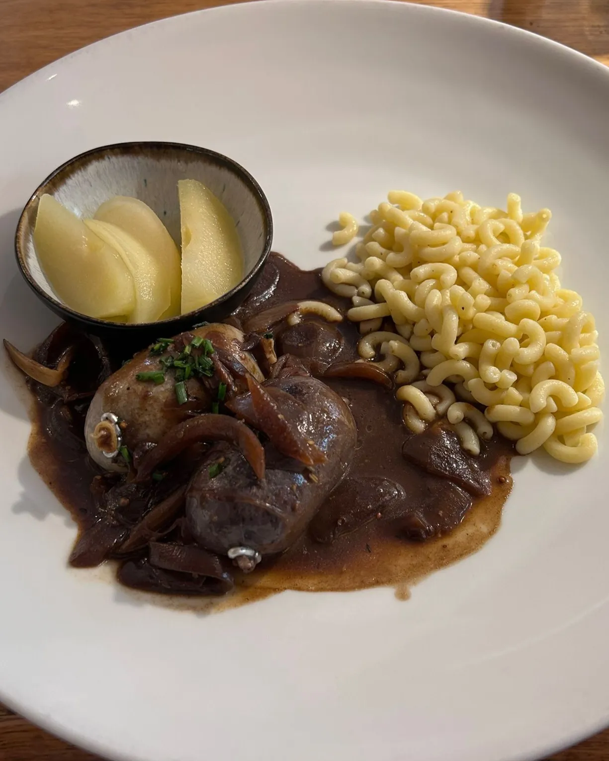 Blood and liver sausage with Hörnli pasta and apple slices at Harmonie Bern