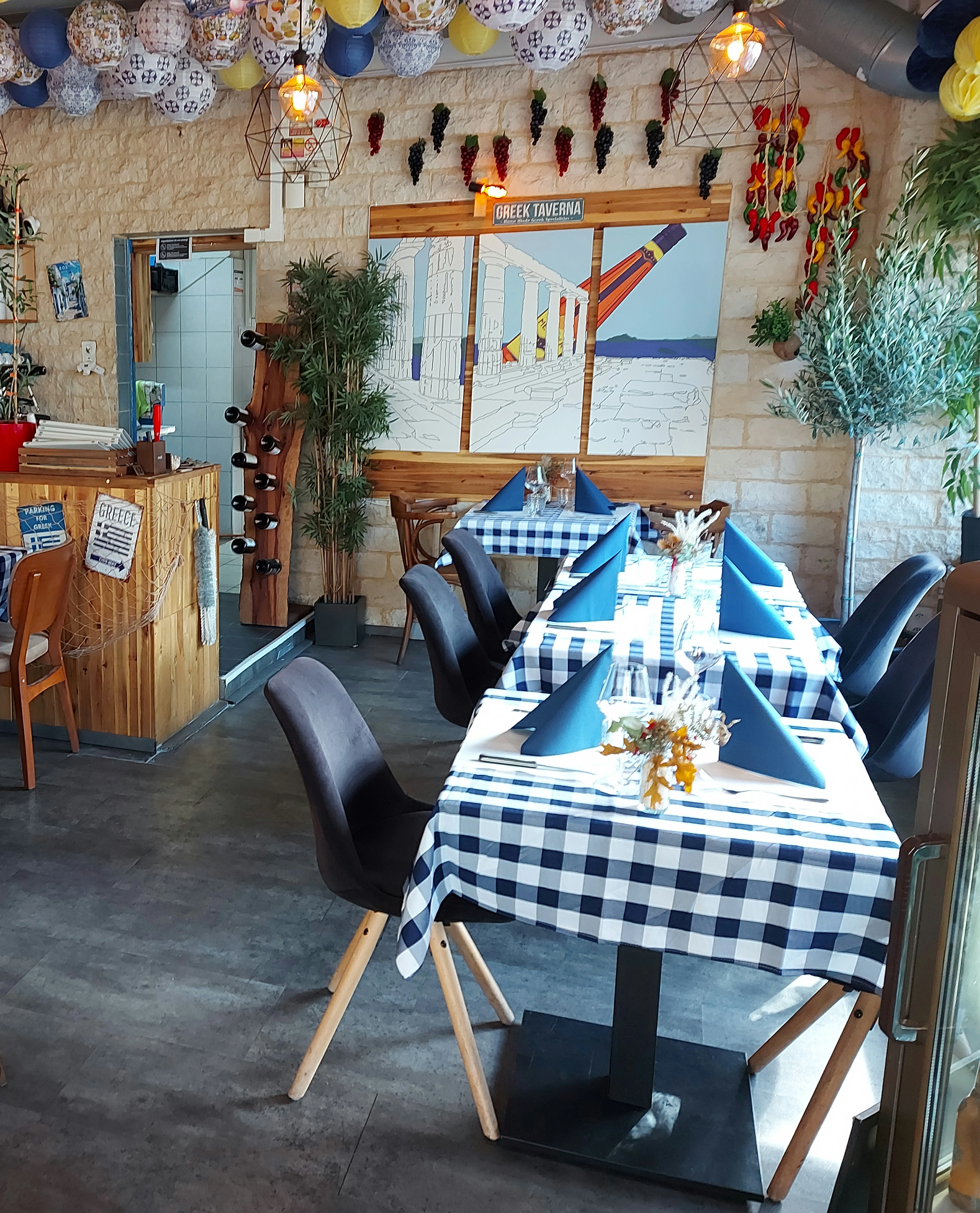Bright interior of Little Greek Taverna with blue-and-white decor