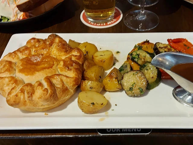 Beef & Guinness pie with pan-fried potatoes and roasted vegetables at McCarthys Bern