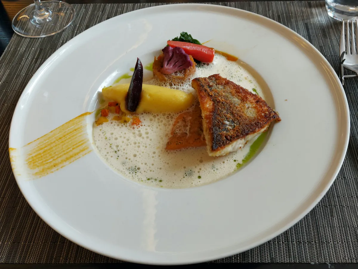 Steamed char and pan-seared sea bass with mashed potatoes, sauerkraut, and champagne foam