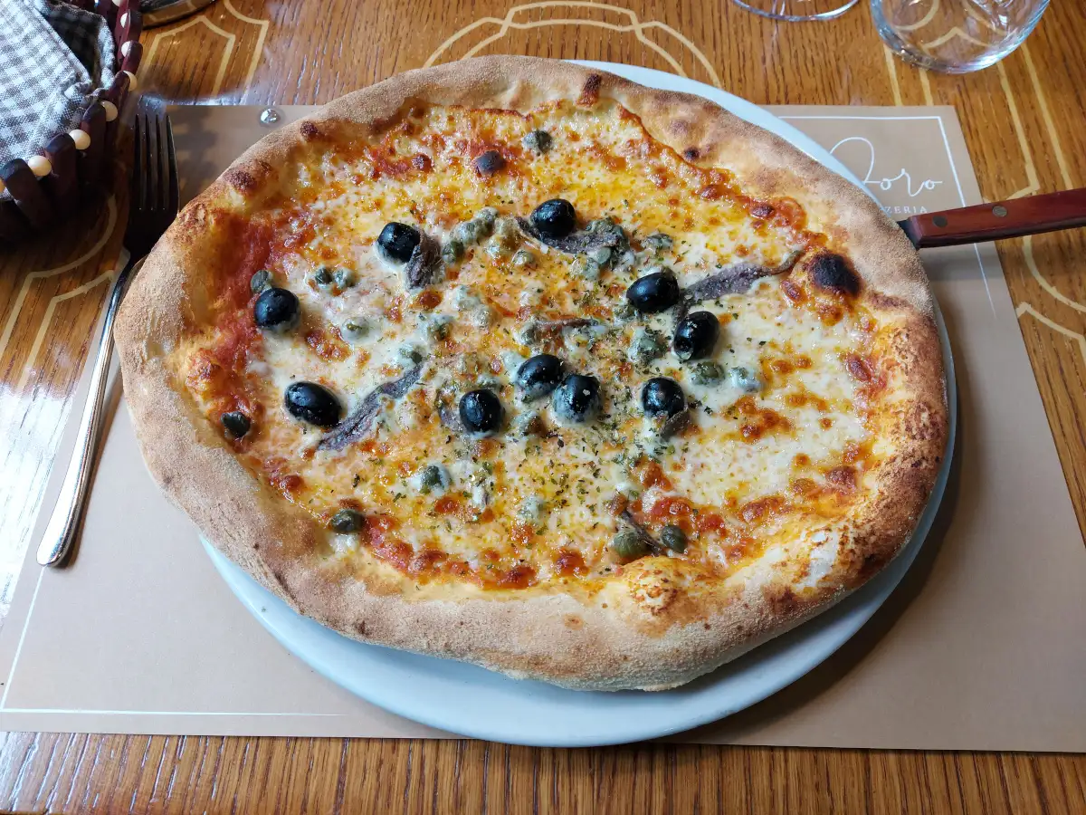 Pizza Napoli with anchovies, olives and capers at Pomodoro Bern