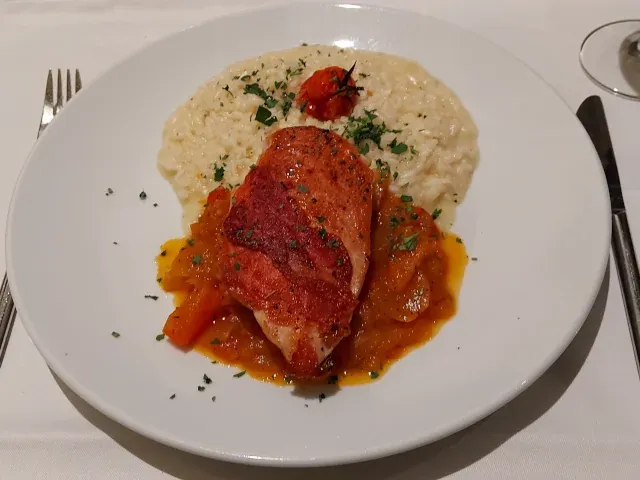 Chicken Saltimbocca at Restaurant Eleven Bern with risotto and tomato ragout